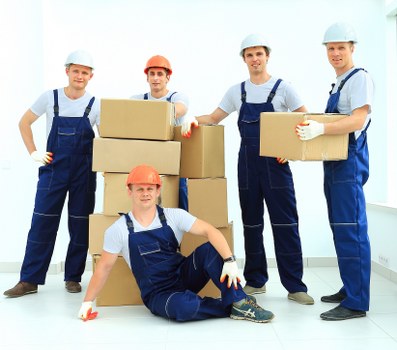 Removal van and moving team outside a Surrey residential property