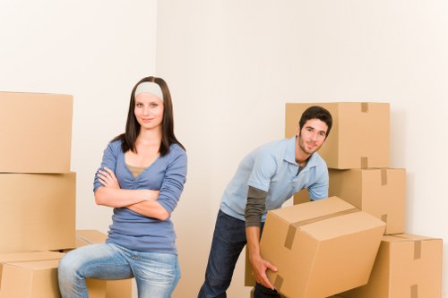 Local movers handling household furniture in a Surrey property