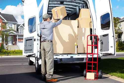 Moving team carrying furniture through a Surrey home