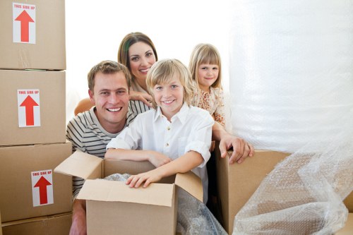 Professional removal team handling boxes in a Surrey property